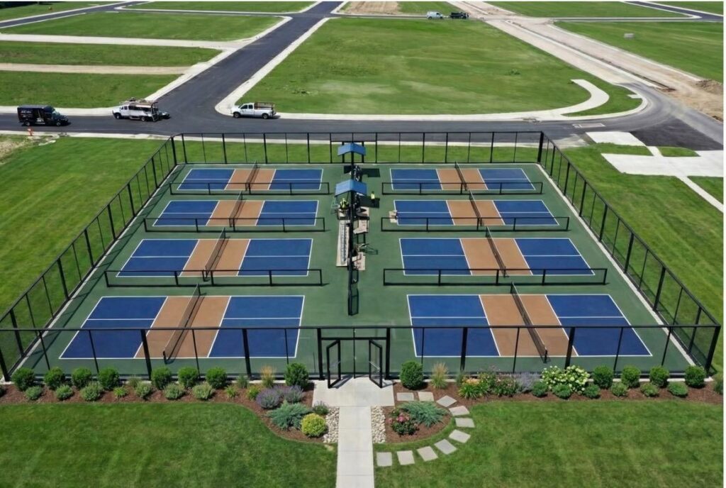 Modern glass pickleball enclosure designed to match the architectural language and facade of a Class-A multifamily development.