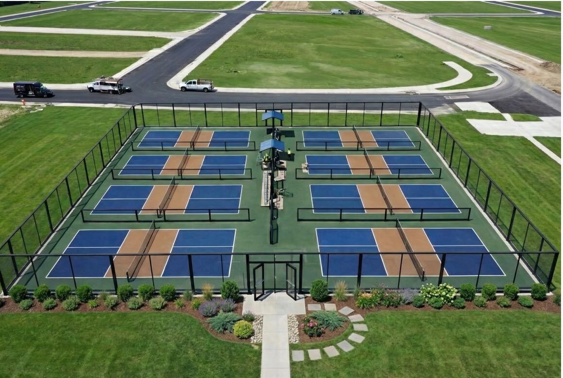 Modern glass pickleball enclosure designed to match the architectural language and facade of a Class-A multifamily development.