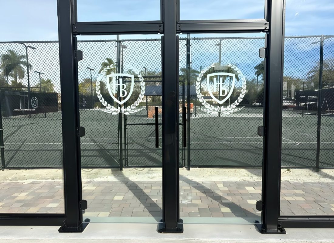 PICKLEGLASS enclosure with custom-etched club crest